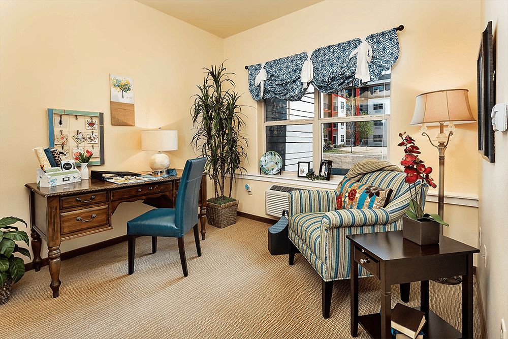 Senior living community interior featuring modern furniture and decor in a cozy living room setting.
