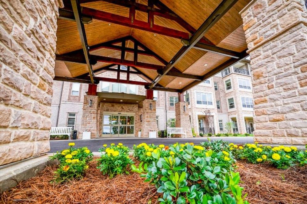 Harmony At Enterprise senior living community featuring urban architecture and lush gardens.