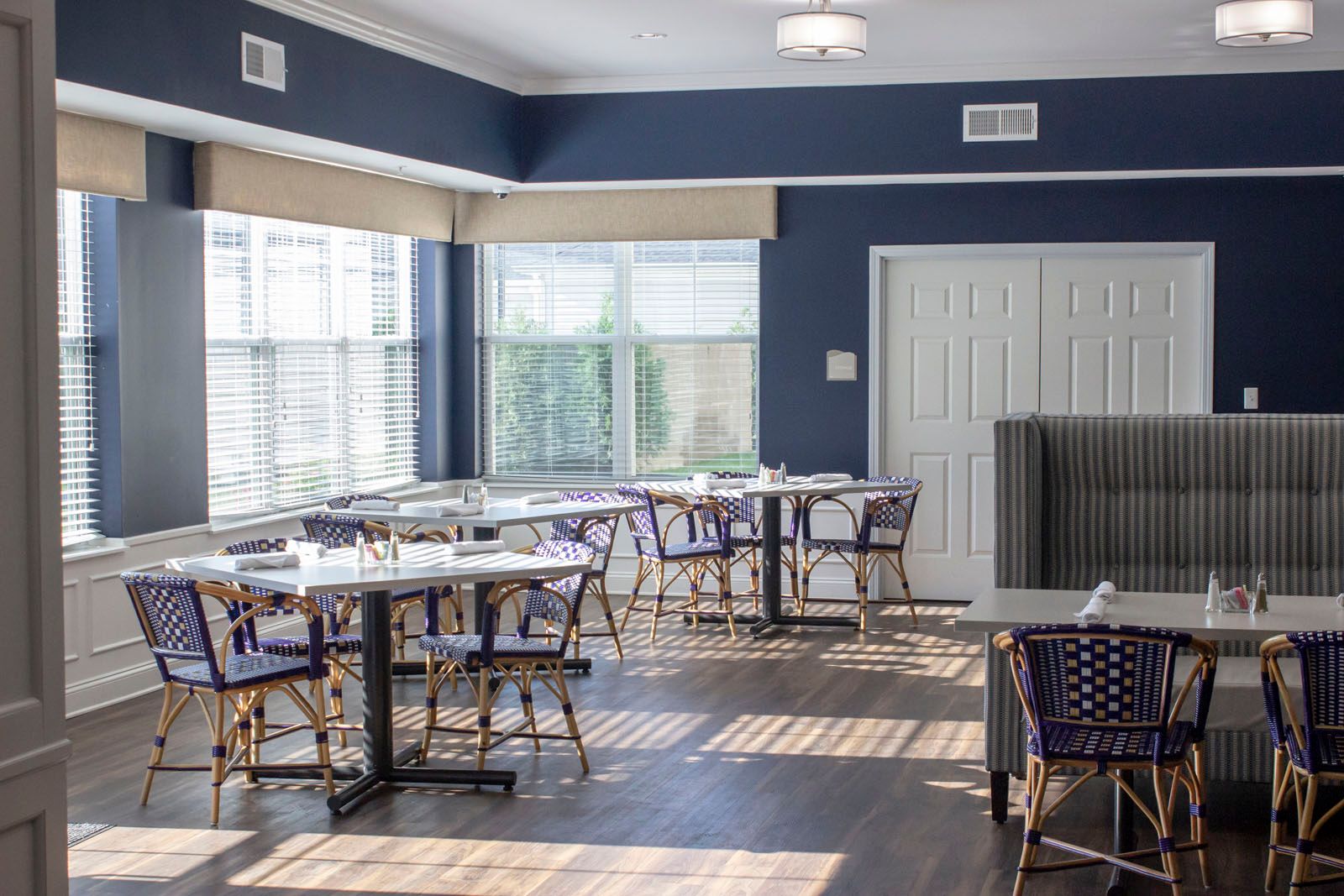 Interior view of Storypoint Collierville senior living community featuring a dining area with wooden furniture.