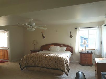 Interior view of a bedroom at Ark Of Caring Assisted Living Home with modern decor.