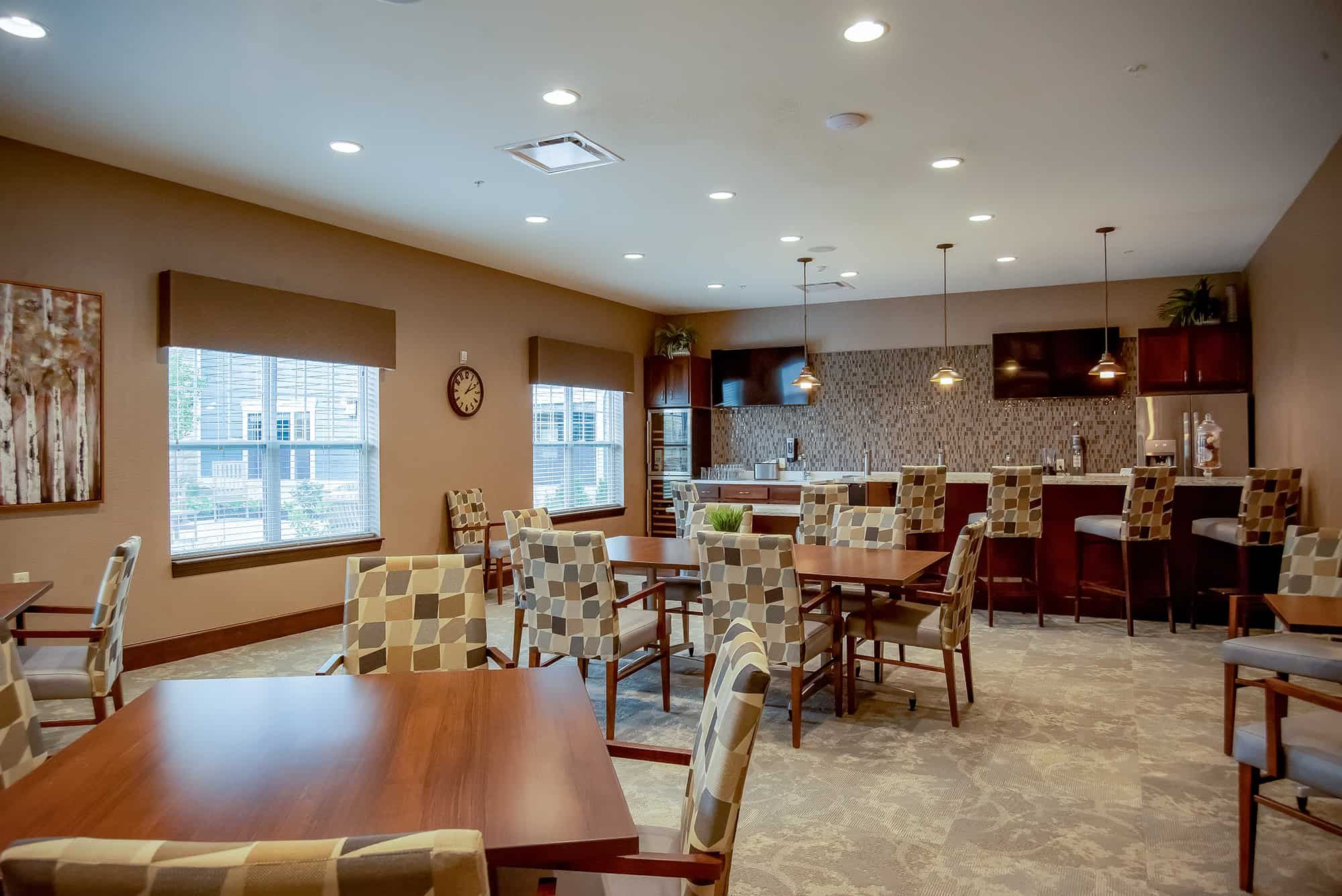 Interior view of Deerfield senior living community featuring dining room, lounge and home decor.