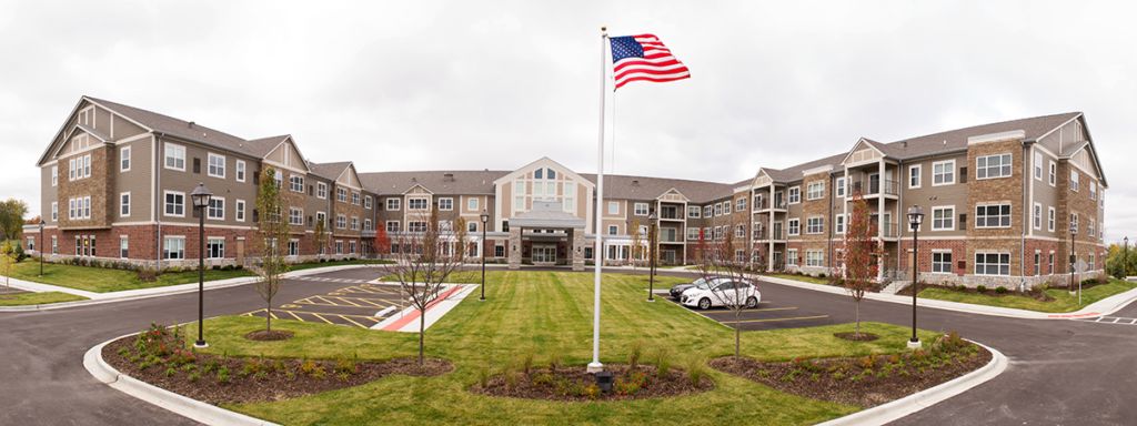 Clarendale of Mokena senior living community building in a suburban neighborhood, with cars.