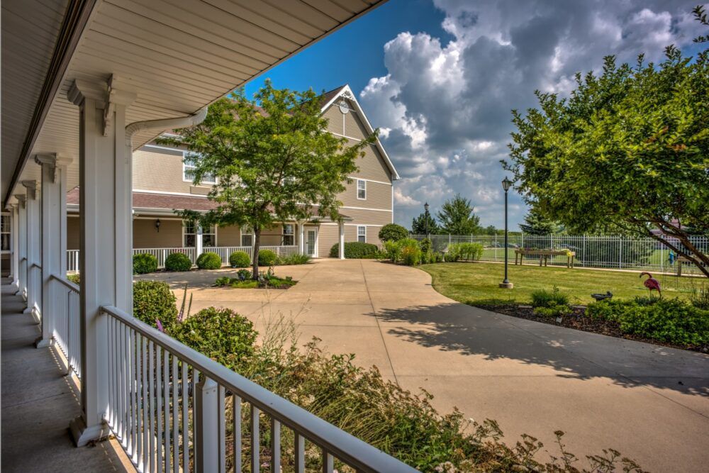 Scenic view of Morningside of Sterling senior living community with lush greenery and birds.