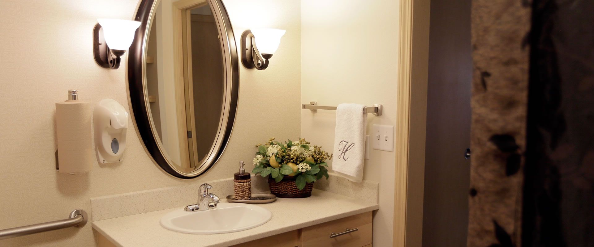 Senior living community Highgate at Prescott Lakes featuring a sink, plants, and decor.