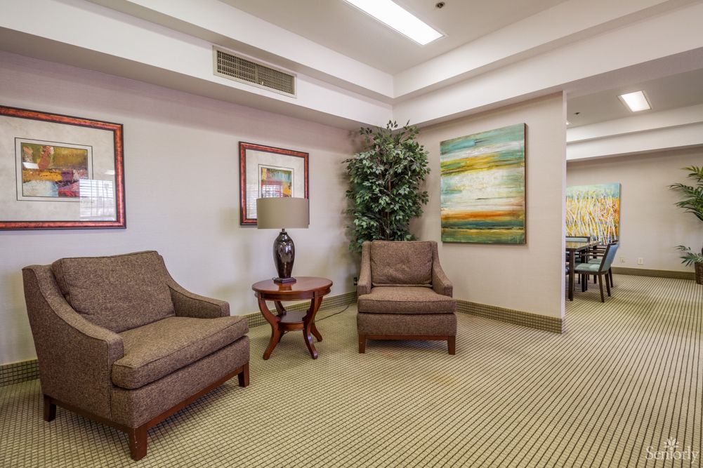 Interior view of Montclair Royale Senior Living featuring elegant decor, furniture, and artwork.