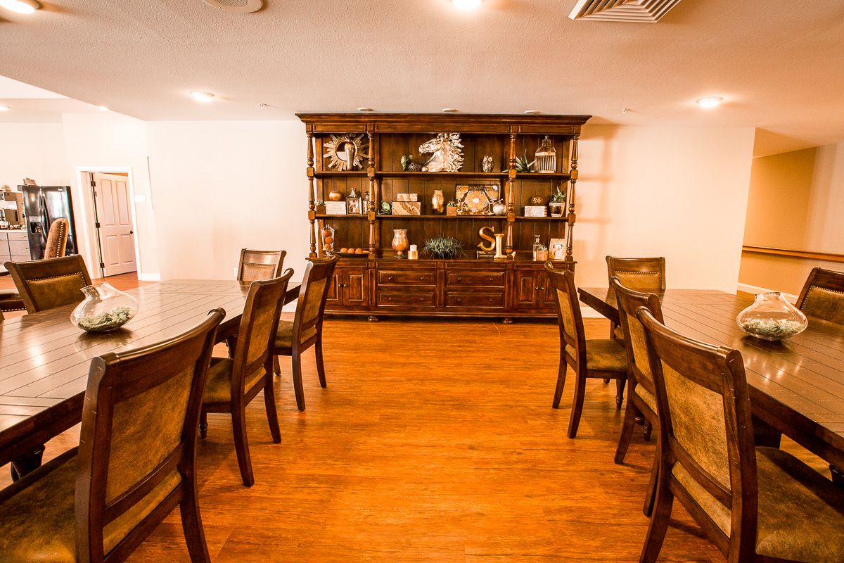 Interior view of Wood Hardwood senior living community featuring dining room with stained wood furniture.