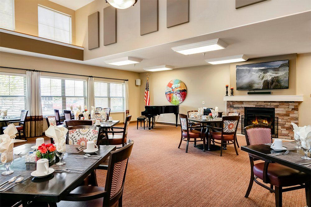 Interior view of MorningStar senior living community in Boise, featuring dining area, piano, and decor.
