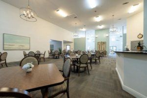 Interior view of SummerHouse Bay Cove senior living community featuring dining and reception areas.