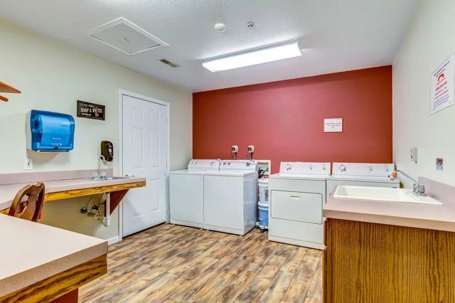 Interior view of Brookstone Estates of Fairfield featuring laundry appliances, sink, and mailbox.