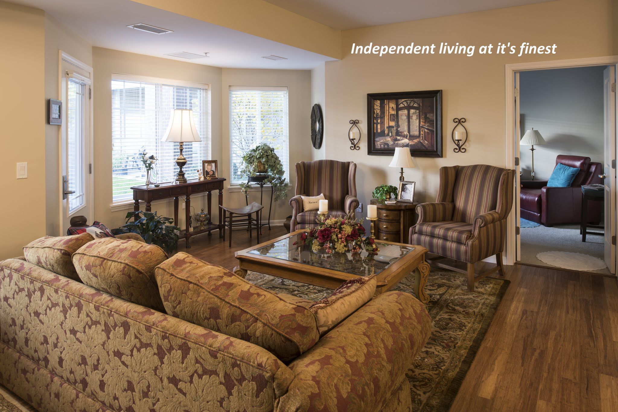 Senior living room interior at The Lodge of Northbrook featuring hardwood flooring and cozy decor.