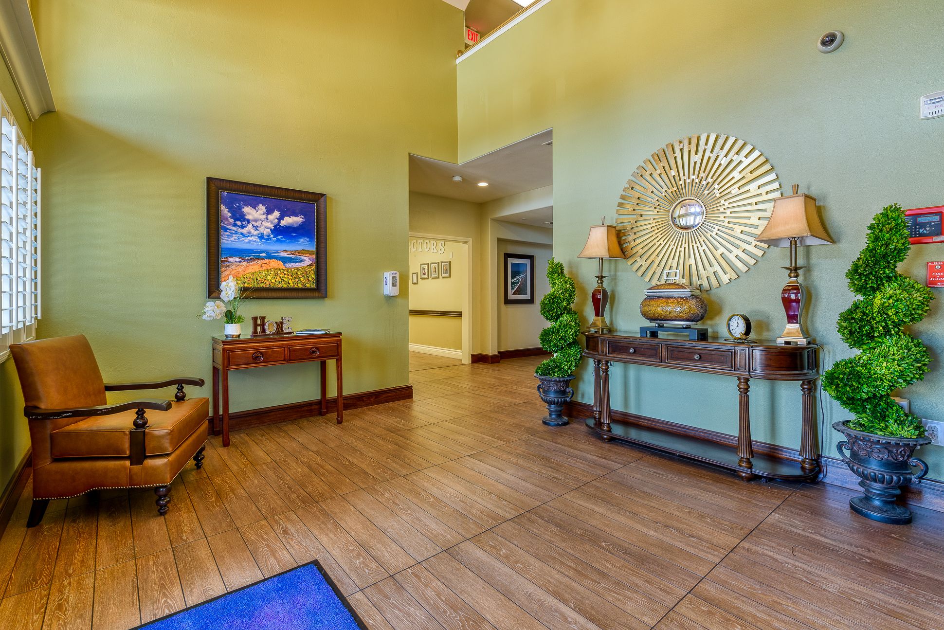 Interior view of Pacifica Senior Living South Coast featuring hardwood floors, furniture, and home decor.