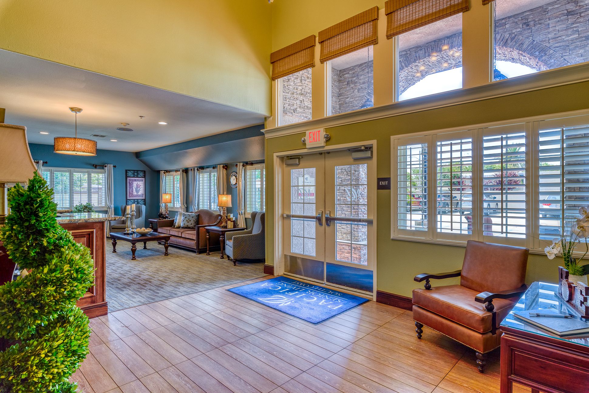Interior view of Pacifica Senior Living South Coast with hardwood floors, furniture, and decor.