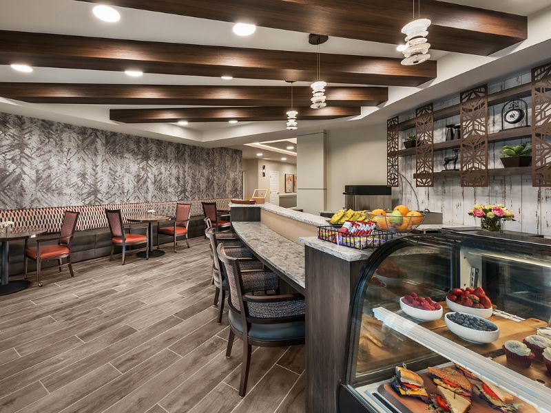 Interior view of Cadence At Rancho Cucamonga senior living community's cafeteria with modern furniture.