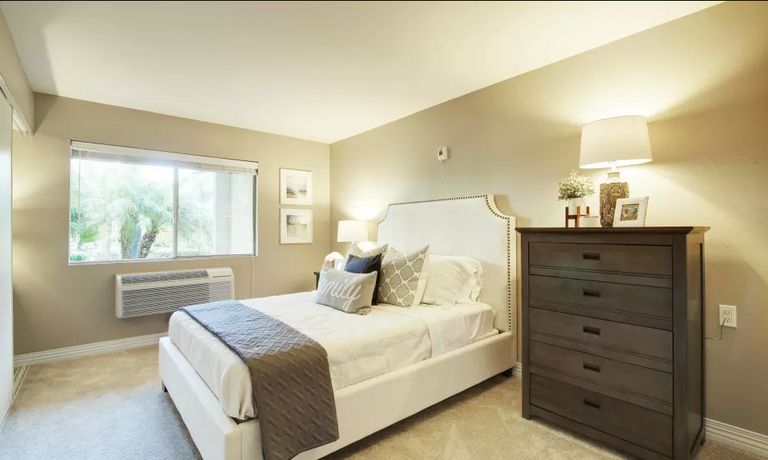 Interior view of a comfortable bedroom at Coastal Heights Senior Living with tasteful decor.