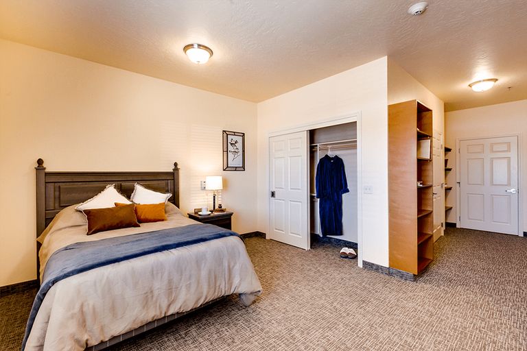 Interior view of a well-furnished bedroom at CornerStone Senior Living community.