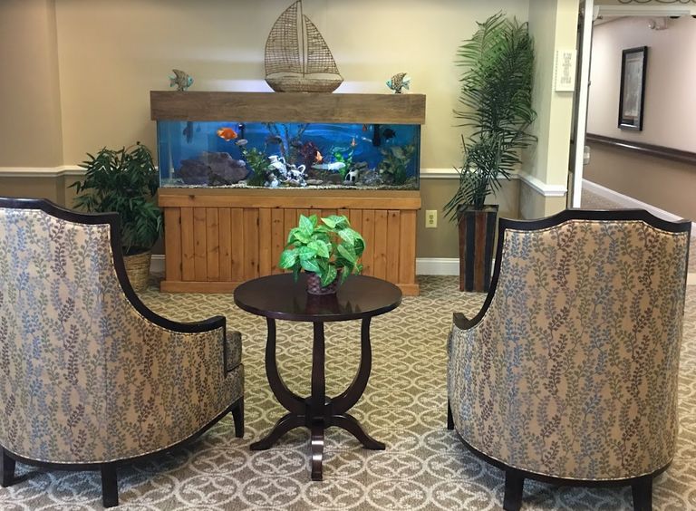 Interior view of The Gardens of Waterford senior living community featuring aquarium with sea life.