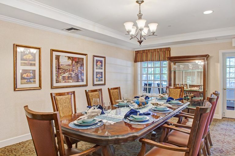 Senior living community Sunrise of Park Ridge featuring elegant dining room with decor.