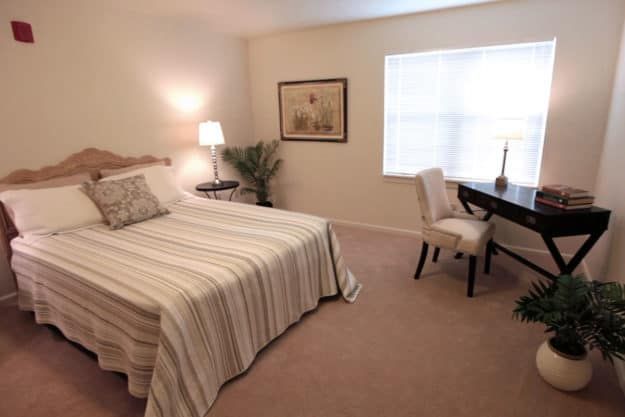 Interior design of a comfortable bedroom at Corner, the senior living community in Silver Maples of Chelsea.