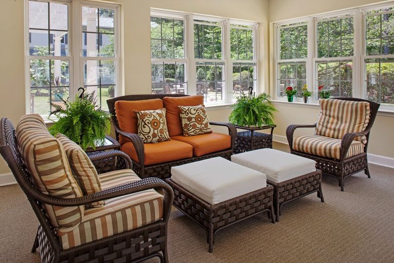Senior living community at North Hills with cozy furniture, plants, home decor, and French windows.