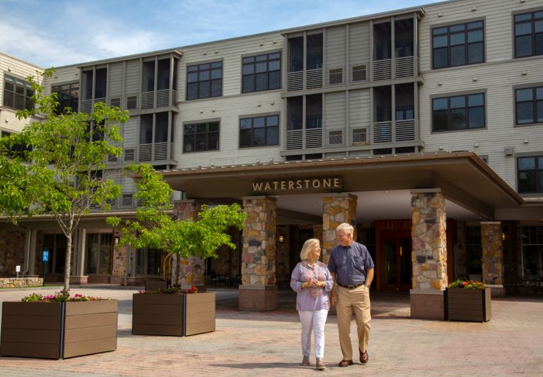 Senior living community, Waterstone at Welley, featuring urban architecture and lush greenery.