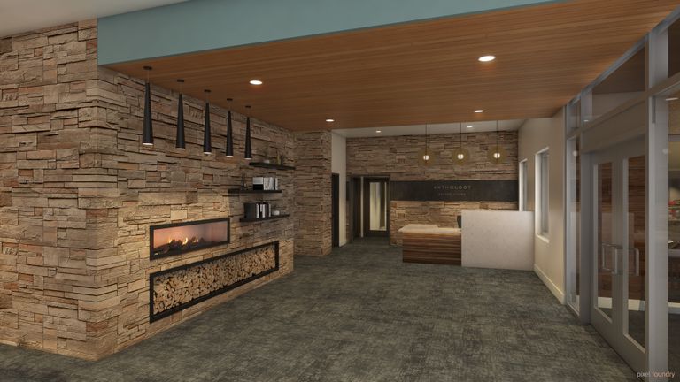 Interior view of Edmonds senior living community featuring a cozy fireplace, wooden flooring and elegant furniture.