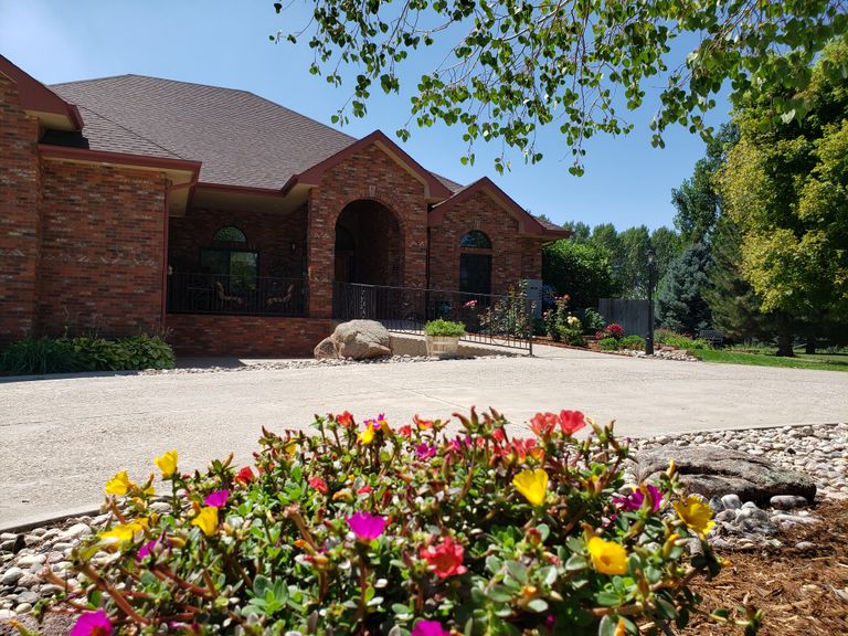 Pathway at Eagles Nest Assisted Living with slate flagstone, geranium garden, and villa.