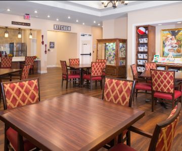 Interior view of Poet's Walk Round Rock senior living community featuring a wood-furnished dining area.